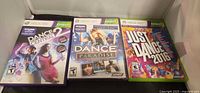 Front view of the three Xbox 360 Kinect dance game cases