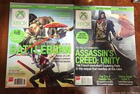 Both magazine covers visible showing Battleborn and Assassin's Creed Unity issues