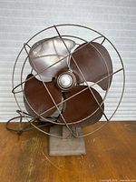 Front view of vintage Sears & Roebuck metal fan showing blades and guard
