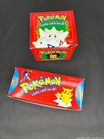 Two boxed items: Togepi gold card box and Clip Buddy box