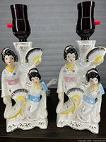 Front view of both Seizan ceramic geisha lamp bases showing design and sockets