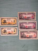 Fronts of all five banknotes displayed on flat surface