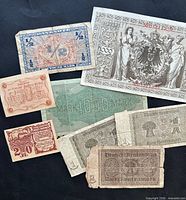 All nine banknotes laid out on black backdrop