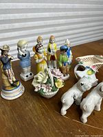 Group view of figurines, animals, bowl, basket and pitcher