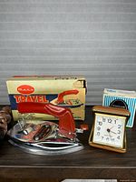 Mars travel iron, Westclox clock and boxes grouped