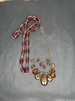 Both necklaces laid flat showing overall design and scale