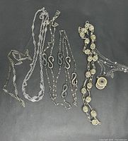 Group shot of all five necklaces laid flat