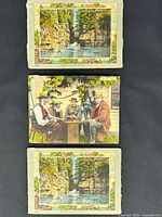 Stacked view of three postcard folders showing cover images