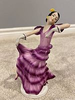 Front view of porcelain dancer figurine showing colour and pose