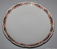 Front view showing floral rim, scalloped edge and overall condition