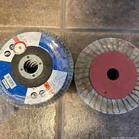 Two stacks of flap discs, left stack shrink wrapped, right stack loose