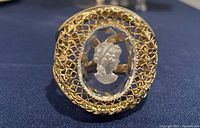 Front view showing filigree frame and glass cameo