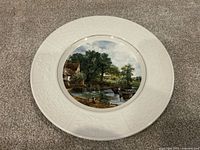 Front of decorative plate showing artwork and rim detail