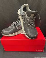 Pair of New Balance 1540v3 shoes on red box