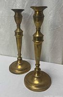 Full view of both brass candlesticks upright