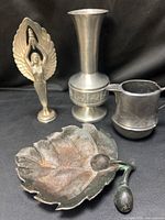 Group shot showing vase, figurine, creamer and leaf dish