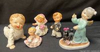 Group shot of all five porcelain figurines