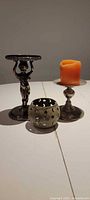 Three candle holders positioned together
