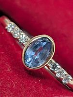 Ring front view showing sapphire and diamond shoulders
