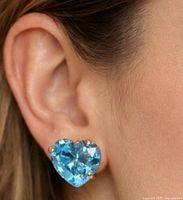 Earring worn on ear for scale