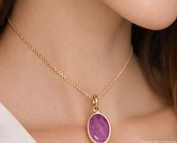 Pendant worn on model showing size and color