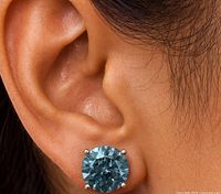 Earring worn, showing scale and blue diamond color