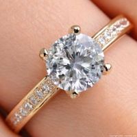 Ring on finger showing full design and stone clarity