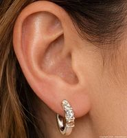 Earring worn in ear showing size and design