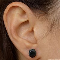 Earring worn on ear displaying size and appearance
