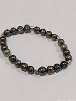 Full view of dyed freshwater pearl stretch bracelet with silver-tone cube spacers