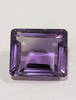 Top view of rectangular step-cut amethyst showing clarity and colour