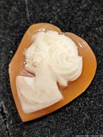 Front view of heart-shaped shell cameo with female profile