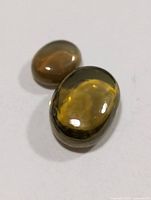 Two cat's eye gemstones on white background