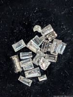 Close-up of loose baguette diamonds on black background