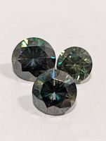 Three round moissanite stones front view