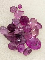 Close-up view of loose rubies showing cuts and colour