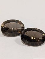 Pair of oval faceted smoky quartz gemstones top view