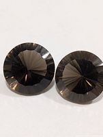 Front view of two round faceted smoky quartz stones
