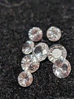 Close-up of loose white sapphires on dark background