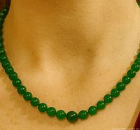 Necklace worn on neck showing beads and clasp area hidden