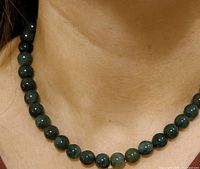 Necklace worn on model showing bead size and color