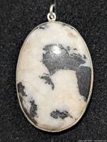 Front view of oval zebra jasper pendant in silver bezel