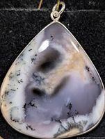 Front view of teardrop dendritic agate pendant in silver bezel