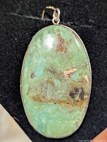 Front view of oval chrysoprase pendant in silver bezel