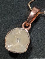 Front view of silver pendant with rough diamond