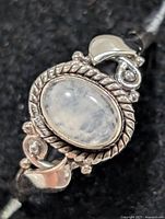 Front view of silver ring with oval moonstone cabochon