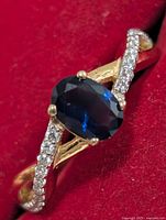 Top view showing oval blue created sapphire and accent stones