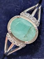 front view showing oval emerald and accent stones