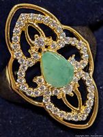 Front view showing pear-shaped green stone and CZ halo