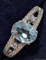 Top view of ring showing blue topaz and CZ accents